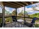 Inviting balcony with seating offering picturesque views of nearby homes and tropical foliage at 9200 Little Gasparilla # 203, Placida, FL 33946