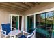 Balcony features sliding glass doors and outdoor seating at 9200 Little Gasparilla # 203, Placida, FL 33946