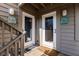 Close-up of inviting unit doorways with nautical décor and welcome mats on the porch at 9200 Little Gasparilla # 203, Placida, FL 33946