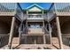Exterior view showcasing the architecture of the wooden decks and staircase at 9200 Little Gasparilla # 203, Placida, FL 33946