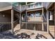 Coastal home featuring multiple wooden decks and staircase, perfect for outdoor living at 9200 Little Gasparilla # 203, Placida, FL 33946