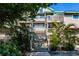 Coastal home featuring multiple decks, lush tropical landscaping, and inviting staircase at 9200 Little Gasparilla # 203, Placida, FL 33946