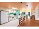 Well lit kitchen with white appliances and colorful ceilings and an open dining area at 9200 Little Gasparilla # 203, Placida, FL 33946