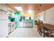 An open concept kitchen with colorful ceiling and a dining area at 9200 Little Gasparilla # 203, Placida, FL 33946