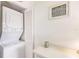 A white stacked washer and dryer are located adjacent to white cabinets at 9200 Little Gasparilla # 203, Placida, FL 33946