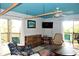 Comfortable living room with unique furnishings, a flat screen TV, and access to the balcony at 9200 Little Gasparilla # 203, Placida, FL 33946