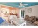 Inviting living room with a tile-topped coffee table, fan, and access to a dining area and kitchen at 9200 Little Gasparilla # 203, Placida, FL 33946