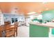 Cozy open concept living room and kitchen area with a colorful ceiling and access to the balcony at 9200 Little Gasparilla # 203, Placida, FL 33946