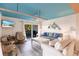 Bright living room with stylish furnishings, ceiling fan and sliding glass door to balcony at 9200 Little Gasparilla # 203, Placida, FL 33946
