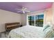 Bedroom featuring a large window view to the outside and a light purple ceiling with a fan at 9200 Little Gasparilla # 203, Placida, FL 33946
