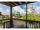 Scenic balcony view of neighboring homes, lush foliage, and the serene ocean at 9200 Little Gasparilla # 203, Placida, FL 33946