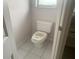 Dirty white toilet and tile flooring at 1 Clubhouse Rd, Rotonda West, FL 33947