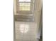 Bathroom with a white tiled floor and a large tub situated under a window at 1 Clubhouse Rd, Rotonda West, FL 33947