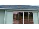 The exterior of the property shows boarded roof and tinted sliding glass doors at 1 Clubhouse Rd, Rotonda West, FL 33947