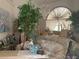 Living room showcasing a large window, chandelier, and a sofa with floral print at 1 Clubhouse Rd, Rotonda West, FL 33947