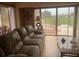 Living room features a large window, sofa, and a coffee table, providing comfortable seating and ample light at 1 Clubhouse Rd, Rotonda West, FL 33947