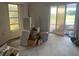 A large sliding glass door opening to the outside provides ample natural light to this otherwise cluttered room at 1 Clubhouse Rd, Rotonda West, FL 33947