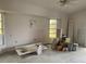 Bare room featuring paint buckets, a sink, and windows allowing natural light at 1 Clubhouse Rd, Rotonda West, FL 33947