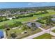 Aerial shot showcasing the property's location near a golf course, lush greenery, and a residential community at 1002 Rotonda Cir, Rotonda West, FL 33947