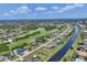 A wide aerial view showing a waterway running through a community of houses and golf courses at 1002 Rotonda Cir, Rotonda West, FL 33947