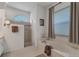 Bright bathroom featuring a tiled shower, soaking tub, and large window at 1002 Rotonda Cir, Rotonda West, FL 33947