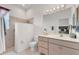 Well lit bathroom featuring a walk-in shower, updated fixtures, and white vanity at 1002 Rotonda Cir, Rotonda West, FL 33947