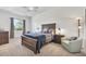 The bedroom features a large bed, soft carpet, and a comfortable chair at 1002 Rotonda Cir, Rotonda West, FL 33947
