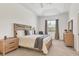 Bedroom with a tray ceiling, plush carpet, and natural wood furniture at 1002 Rotonda Cir, Rotonda West, FL 33947