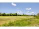 Scenic view of a lush green golf course with mature trees under a bright blue sky with scattered clouds at 1002 Rotonda Cir, Rotonda West, FL 33947