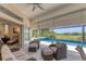 Cozy lanai seating area with a view of the pool and lush greenery, perfect for relaxation at 1002 Rotonda Cir, Rotonda West, FL 33947
