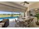 This lanai features an outdoor dining set with a view of the pool and golf course at 1002 Rotonda Cir, Rotonda West, FL 33947