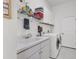 Bright laundry room with white cabinets, a utility sink, and modern washer and dryer at 1002 Rotonda Cir, Rotonda West, FL 33947