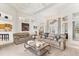 Spacious living room with neutral tones, seamlessly connecting the kitchen and dining areas for easy living at 1002 Rotonda Cir, Rotonda West, FL 33947
