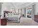 The main bedroom features a trey ceiling, plush carpet and large windows providing ample natural light at 1002 Rotonda Cir, Rotonda West, FL 33947