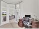 Well-lit office with a view to the living room, wood desk, and carpet at 1002 Rotonda Cir, Rotonda West, FL 33947