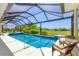 Relaxing screened pool area with a lounge area and golf course view is ideal for outdoor living at 1002 Rotonda Cir, Rotonda West, FL 33947