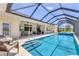 Beautifully designed pool area featuring a clear blue pool, spa, covered patio, and outdoor dining, perfect for entertaining at 1002 Rotonda Cir, Rotonda West, FL 33947