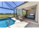 A covered pool area overlooks the living room and features seating with golf course view at 1002 Rotonda Cir, Rotonda West, FL 33947