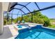 Outdoor screened-in pool and spa, including chairs and other outdoor furnishings, surrounded by lush green trees and landscaping at 1002 Rotonda Cir, Rotonda West, FL 33947