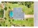 Aerial view shows the screened pool and the house's layout on the lot at 1040 Caples St, Englewood, FL 34223