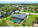 An aerial view shows the pool, screened in patio, lawn, landscaping and the house at 1040 Caples St, Englewood, FL 34223