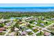 Aerial view showcases a residential area with waterfront views; home of interest is circled in white at 1040 Caples St, Englewood, FL 34223