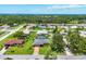 Scenic aerial perspective of a quiet neighborhood with tree-lined streets and well-spaced single-Gathering homes at 1040 Caples St, Englewood, FL 34223