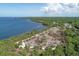 Panoramic aerial view of a park blending lush greenery with tranquil waterfront access and open skies at 1040 Caples St, Englewood, FL 34223