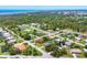 Picturesque aerial shot of a residential neighborhood with lush greenery and a glimpse of the bay at 1040 Caples St, Englewood, FL 34223