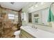Bathroom featuring a tiled shower with a built-in shelf, and a decorative framed mirror at 1040 Caples St, Englewood, FL 34223