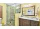 Bathroom featuring a glass shower, vanity with a sink and an illuminated light fixture at 1040 Caples St, Englewood, FL 34223