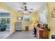 Bright home office with a work desk, storage dresser, and natural light streaming through the window at 1040 Caples St, Englewood, FL 34223