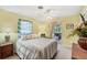 Comfortable bedroom with sliding door to porch, ceiling fan and furnishings at 1040 Caples St, Englewood, FL 34223