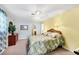 Cozy bedroom featuring a queen bed, ceiling fan, and dresser with decorative greenery at 1040 Caples St, Englewood, FL 34223